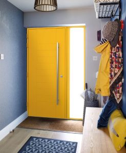 Modern hallway featuring a vibrant yellow Smarts aluminium front door with a full-length side light, enhancing contemporary home entrances.